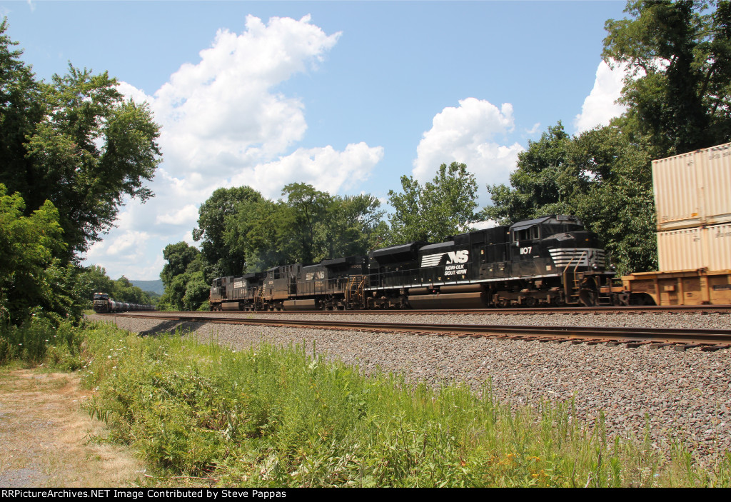 NS 9670 heads a westbound stack train, while 21G holds on the siding